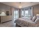 Relaxing bedroom featuring large windows, neutral tones, and plenty of natural light at 36925 N Stoneware Dr, Queen Creek, AZ 85140