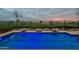Backyard pool overlooks the manicured golf course, with a wrought iron fence ensuring safety and a great view at 36925 N Stoneware Dr, Queen Creek, AZ 85140