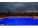 Backyard swimming pool with fountain features, perimeter lighting, and night sky at 36925 N Stoneware Dr, Queen Creek, AZ 85140