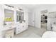 Elegant bathroom with double vanity, walk-in closet, and soaking tub at 39015 N 6Th Dr, Phoenix, AZ 85086
