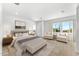 Main bedroom with plush bed and two accent chairs at 39015 N 6Th Dr, Phoenix, AZ 85086