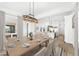 Bright dining room features a wood table and access to the back patio at 39015 N 6Th Dr, Phoenix, AZ 85086