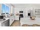 Modern kitchen with white cabinets, large island, and stainless steel appliances at 39015 N 6Th Dr, Phoenix, AZ 85086