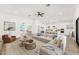 Spacious living area featuring a comfortable sectional sofa and adjacent kitchen at 39015 N 6Th Dr, Phoenix, AZ 85086