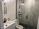 Modern bathroom with white vanity, black fixtures, and a walk-in shower at 4016 W Wagon Wheel Dr, Phoenix, AZ 85051