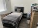 Small bedroom with twin bed, window coverings, and dark flooring at 4016 W Wagon Wheel Dr, Phoenix, AZ 85051