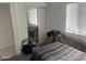 Bedroom with a bed, mirrored closet doors, and window coverings at 4016 W Wagon Wheel Dr, Phoenix, AZ 85051