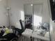 Bedroom with a bed, desk, and mirrored closet at 4016 W Wagon Wheel Dr, Phoenix, AZ 85051