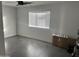 Simple bedroom with gray tile floor and window at 4016 W Wagon Wheel Dr, Phoenix, AZ 85051