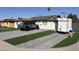 Modern home exterior with artificial turf and driveway at 4016 W Wagon Wheel Dr, Phoenix, AZ 85051