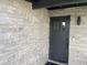 Modern front door with stone facade and doorbell at 4016 W Wagon Wheel Dr, Phoenix, AZ 85051