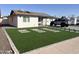 Landscaped front yard with artificial turf and stone pathway at 4016 W Wagon Wheel Dr, Phoenix, AZ 85051