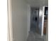 Clean hallway with white walls and tile flooring at 4016 W Wagon Wheel Dr, Phoenix, AZ 85051