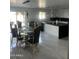 Elegant kitchen with a large island, modern cabinetry, and a glass dining table at 4016 W Wagon Wheel Dr, Phoenix, AZ 85051