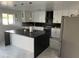 Stylish kitchen with a large island, black countertops, and white cabinetry at 4016 W Wagon Wheel Dr, Phoenix, AZ 85051