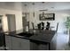 Modern kitchen island with black countertop and built-in sink at 4016 W Wagon Wheel Dr, Phoenix, AZ 85051