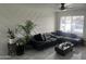 Spacious living room featuring a black sectional sofa and geometric wall design at 4016 W Wagon Wheel Dr, Phoenix, AZ 85051