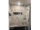 Modern shower with marble tile and frameless glass at 4016 W Wagon Wheel Dr, Phoenix, AZ 85051