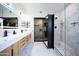 Modern bathroom with double vanity, walk-in shower, and large closet at 4358 E Anderson Dr, Phoenix, AZ 85032