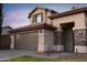 Two-story house with brown garage door and stone accents at 4358 E Anderson Dr, Phoenix, AZ 85032