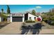 Property's front view, driveway, and surrounding landscape at 5444 E Virginia Ave, Phoenix, AZ 85008