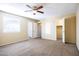 Bright bedroom with neutral walls, carpet flooring, ceiling fan and a large closet at 625 E Judi Dr, Casa Grande, AZ 85122