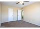 Bedroom with carpet, ceiling fan, and access to bathroom at 625 E Judi Dr, Casa Grande, AZ 85122