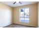 Well-lit bedroom with neutral walls, carpet flooring, and a ceiling fan at 625 E Judi Dr, Casa Grande, AZ 85122