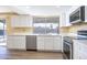 Modern kitchen featuring white cabinets, stainless steel appliances, and a quartz countertop at 625 E Judi Dr, Casa Grande, AZ 85122