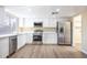 Bright kitchen with white cabinets, stainless steel appliances, and quartz countertops at 625 E Judi Dr, Casa Grande, AZ 85122
