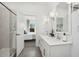 Double vanity bathroom with white cabinets and marble shower at 7645 W Minton St, Laveen, AZ 85339