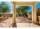 Neatly landscaped backyard with covered patio and brick pavers at 8209 W Lane Ave, Glendale, AZ 85303