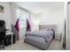Bedroom with a bed, desk, and purple accents at 8209 W Lane Ave, Glendale, AZ 85303