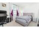Bedroom with a bed, desk, and purple accents at 8209 W Lane Ave, Glendale, AZ 85303