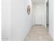 Bright and airy hallway with tile flooring and neutral walls at 8209 W Lane Ave, Glendale, AZ 85303