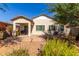 Single story home with backyard patio and desert landscaping at 8209 W Lane Ave, Glendale, AZ 85303