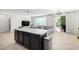 Kitchen island that overlooks living room with access to backyard at 8209 W Lane Ave, Glendale, AZ 85303