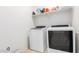 Laundry room with washer, dryer, and shelving at 8209 W Lane Ave, Glendale, AZ 85303