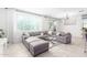 Open living space with gray sectional sofa and access to backyard at 8209 W Lane Ave, Glendale, AZ 85303