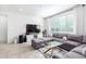 Living room with sectional sofa, large TV, and ample natural light at 8209 W Lane Ave, Glendale, AZ 85303