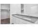 Bathroom with double vanity, granite countertop, and large mirror at 8503 W Mantle Way, Florence, AZ 85132