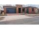 Modern home exterior with stone accents and a two-car garage at 853 W Golden Ore Pass, Apache Junction, AZ 85120