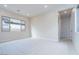 Open living room with large window and access to hallway at 853 W Golden Ore Pass, Apache Junction, AZ 85120