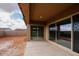 Covered patio with large sliding glass doors leading to backyard at 853 W Golden Ore Pass, Apache Junction, AZ 85120