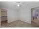 Bedroom with carpet, ceiling fan, and access to bathroom and closet at 8618 W Palo Verde Ave, Peoria, AZ 85345