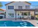 Relaxing backyard oasis featuring a sparkling pool, covered patio, & lush landscaping at 9452 S 51St St, Phoenix, AZ 85044