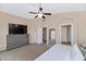 Bright bedroom with large TV, dresser, and carpet flooring at 9452 S 51St St, Phoenix, AZ 85044