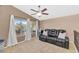 Comfortable bonus room with a ceiling fan, plush seating, and windows overlooking the yard at 9452 S 51St St, Phoenix, AZ 85044