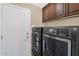 Laundry room with washer, dryer, and cabinets at 9452 S 51St St, Phoenix, AZ 85044