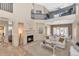 Inviting living room featuring a fireplace, view of upstairs loft, and open access to the dining area at 9452 S 51St St, Phoenix, AZ 85044